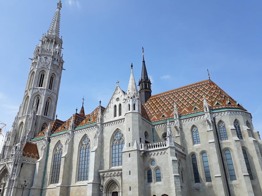 Budapest: Buda Castle Walking Tour & Folk Music Performance - Matthias Church and Fisherman’s Bastion: iconic sights with a human story